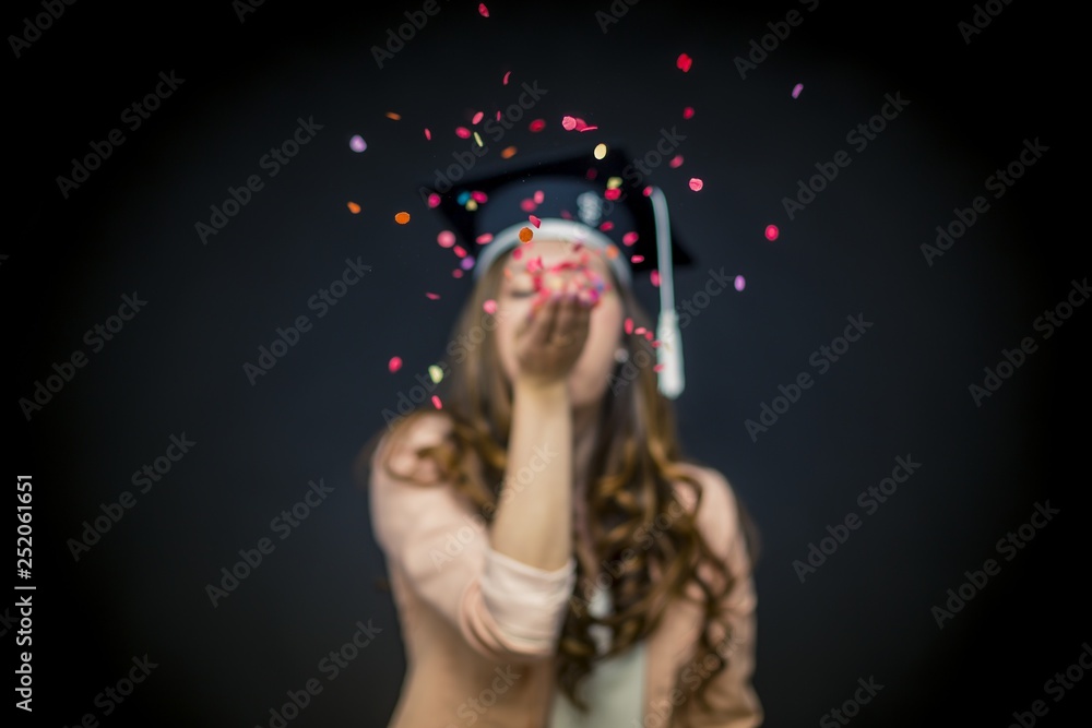 Confetti girl with graduation hat and black background Confetti girl with graduation hat and black background