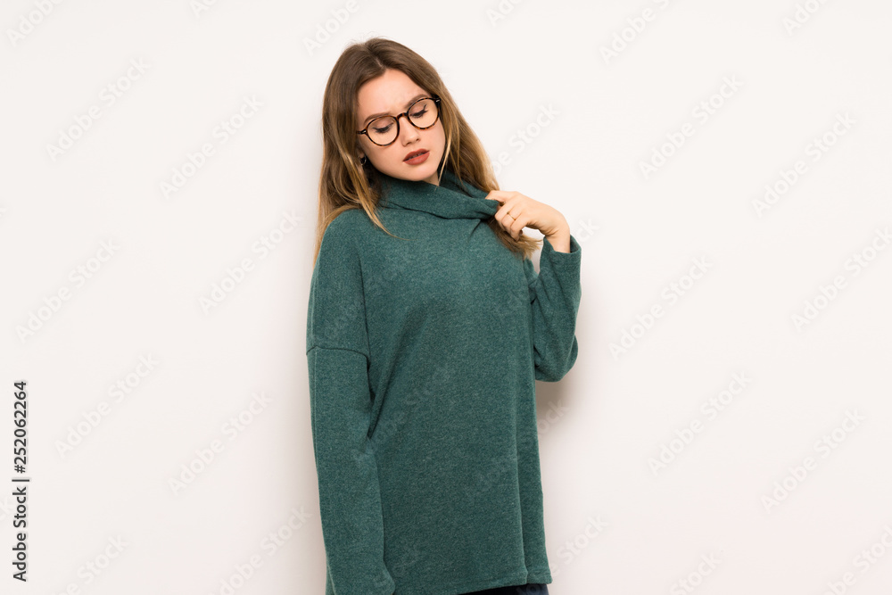 Teenager girl over white wall with tired and sick expression Teenager girl over white wall with tired and sick expression