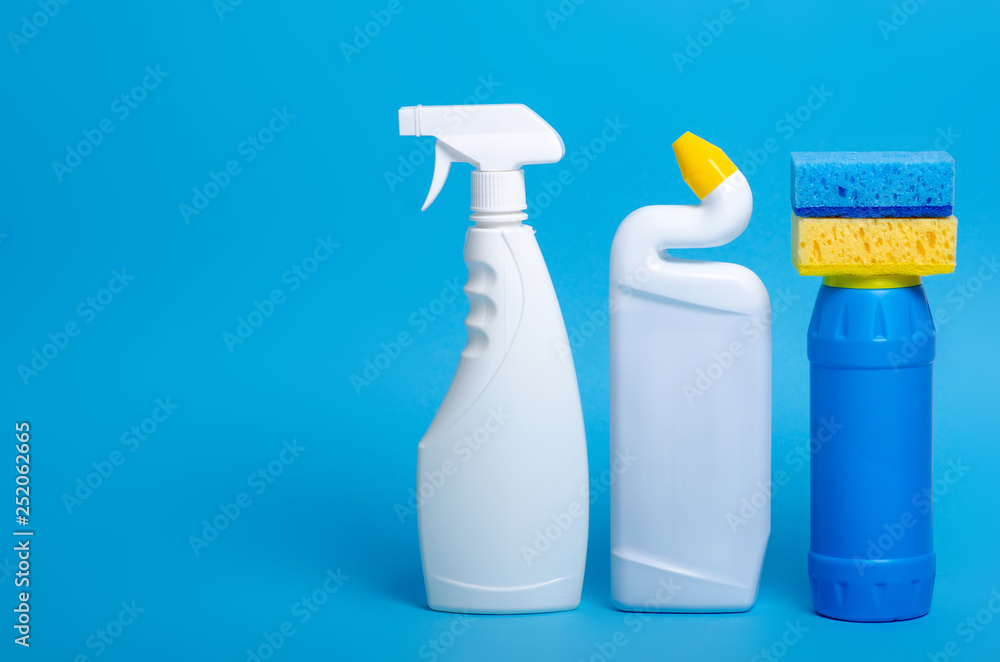 set of cleaning products for home cleaning on blue background set of cleaning products for home cleaning on blue background