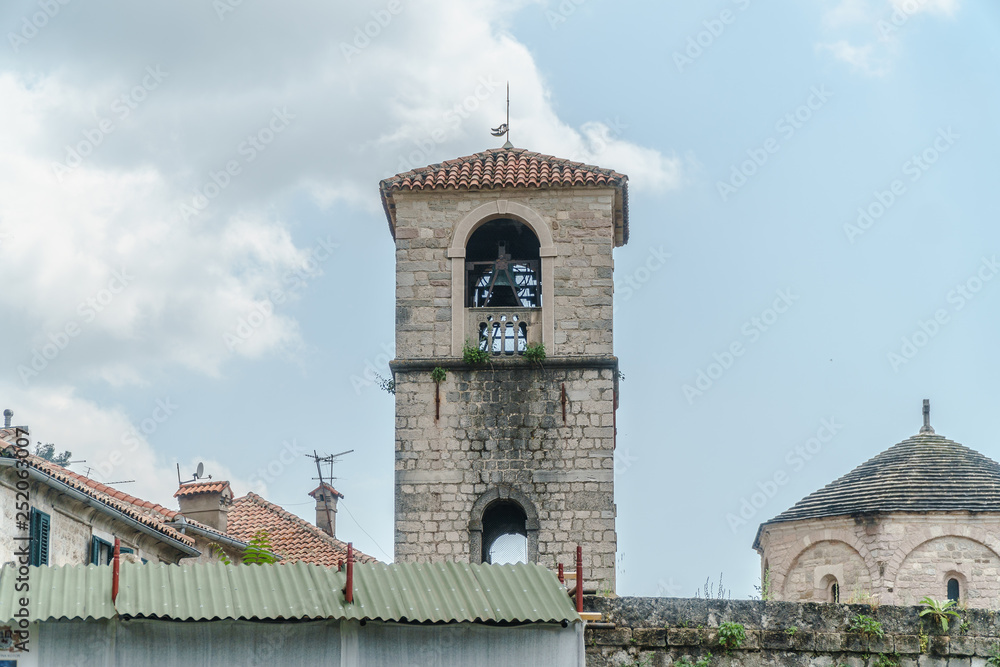 Old tower with bell in european city.
