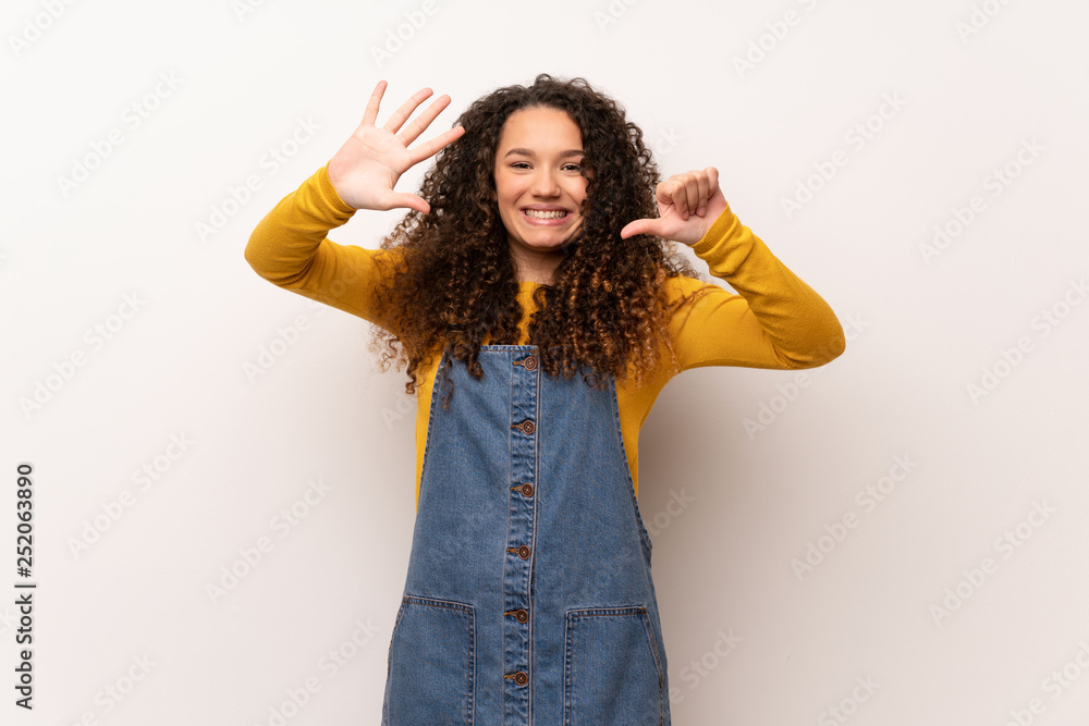 Teenager girl with red sweater over white wall counting six with fingers Teenager girl with red sweater over white wall counting six with fingers