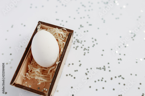 Easter. Easter eggs in a wooden box. Silver. Bokeh.