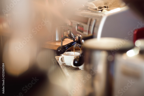 Barista make coffee latte art with espresso machine in cafe.