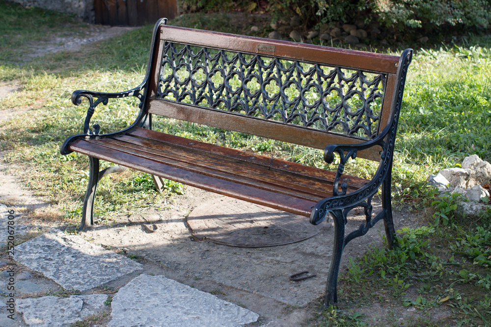 Sitting bench standing on grass on a sunny spring Sitting bench standing on grass on a sunny spring