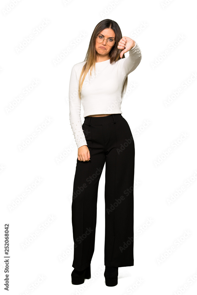 Full body of Pretty woman with glasses showing thumb down sign with negative expression Full body of Pretty woman with glasses showing thumb down sign with negative expression