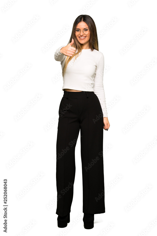 Full body of Pretty woman with glasses giving a thumbs up gesture because something good has happened Full body of Pretty woman with glasses giving a thumbs up gesture because something good has happened