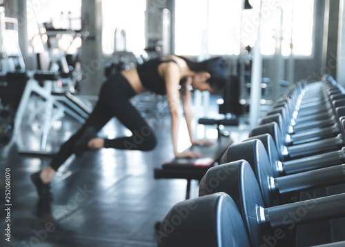 Blur in background, Beautiful women working out in gym alone