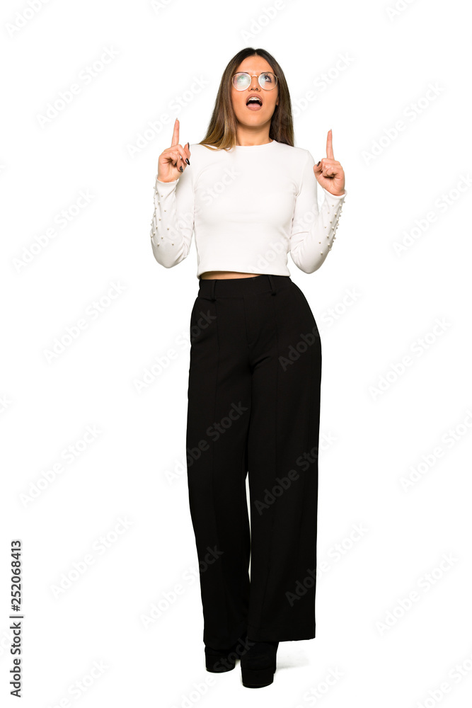 Full body of Pretty woman with glasses surprised and pointing up Full body of Pretty woman with glasses surprised and pointing up