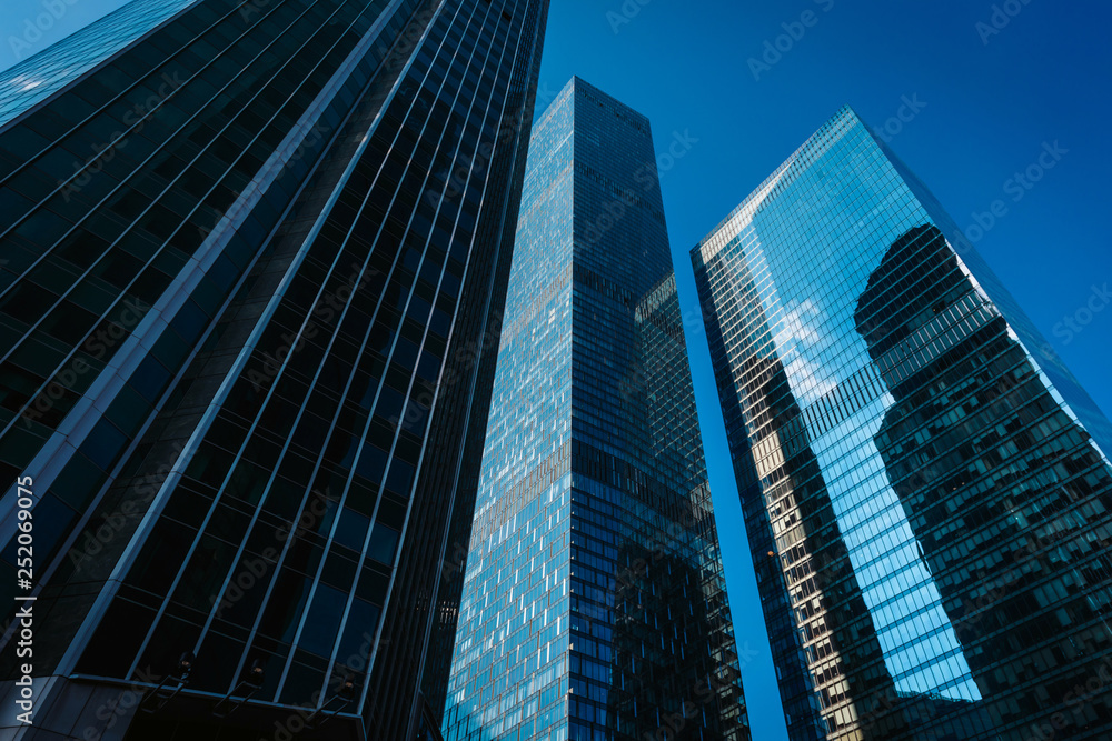 View of Moscow-City skyscrapers. Moscow-City is an office buildings with futuristic design. Architecture landmark of Moscow. Amazing modern constructions against summer blue sky.