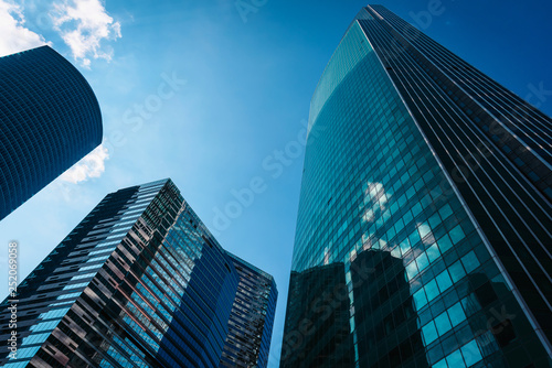 View of Moscow-City skyscrapers. Moscow-City is an office buildings with futuristic design. Architecture landmark of Moscow. Amazing modern constructions against summer blue sky.