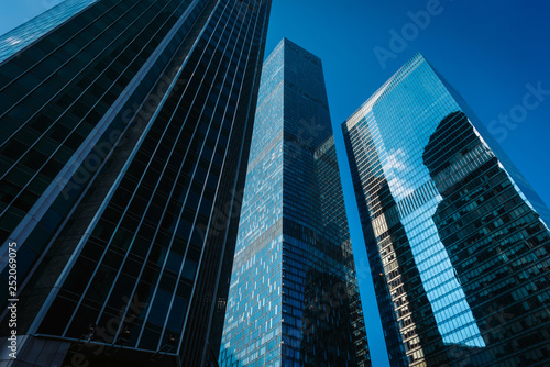 View of Moscow-City skyscrapers. Moscow-City is an office buildings with futuristic design. Architecture landmark of Moscow. Amazing modern constructions against summer blue sky. © ANR Production