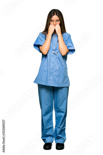 Full body of Young nurse is a little bit nervous and scared putting hands to mouth