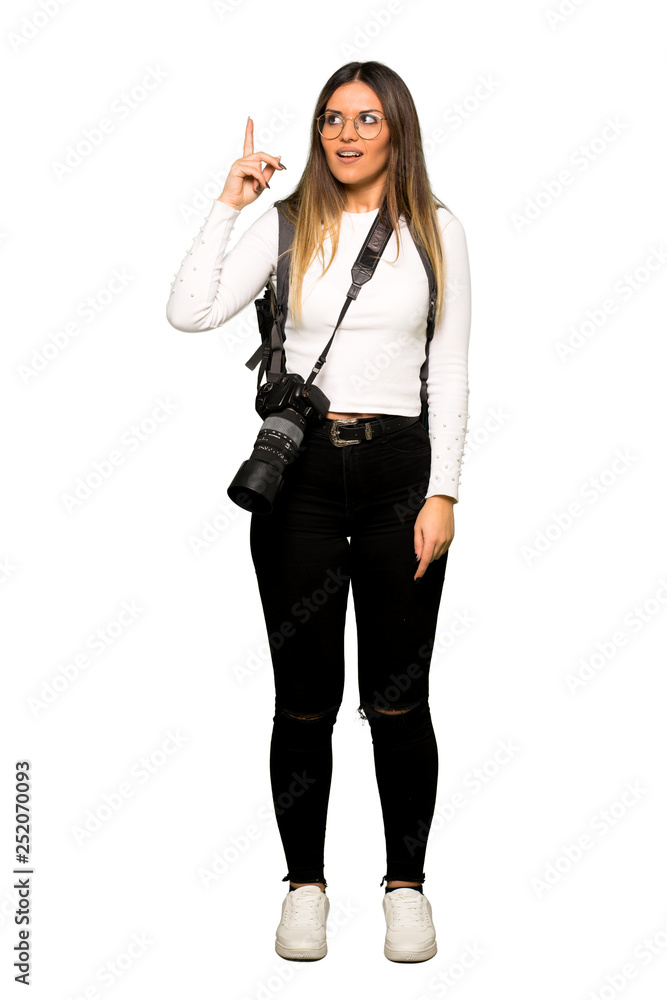 Full body of Young photographer woman intending to realizes the solution while lifting a finger up Full body of Young photographer woman intending to realizes the solution while lifting a finger up