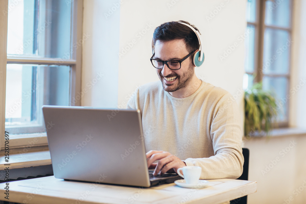 Man in front of laptop computer with headset Man in front of laptop computer with headset