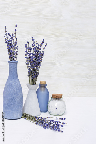 Lavender aromatherapy. Spa background with lavender flowers and essential oil in bottle. Copy space.