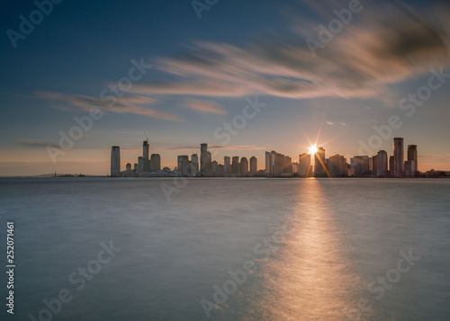 Jersey city with direct sun from hudson river with long exposure © Andriy Stefanyshyn