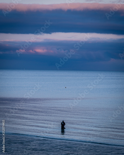 Fisher fishing in Brittany in France at dusk