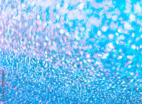 Unfocused background of shining drops of water on the turquoise 