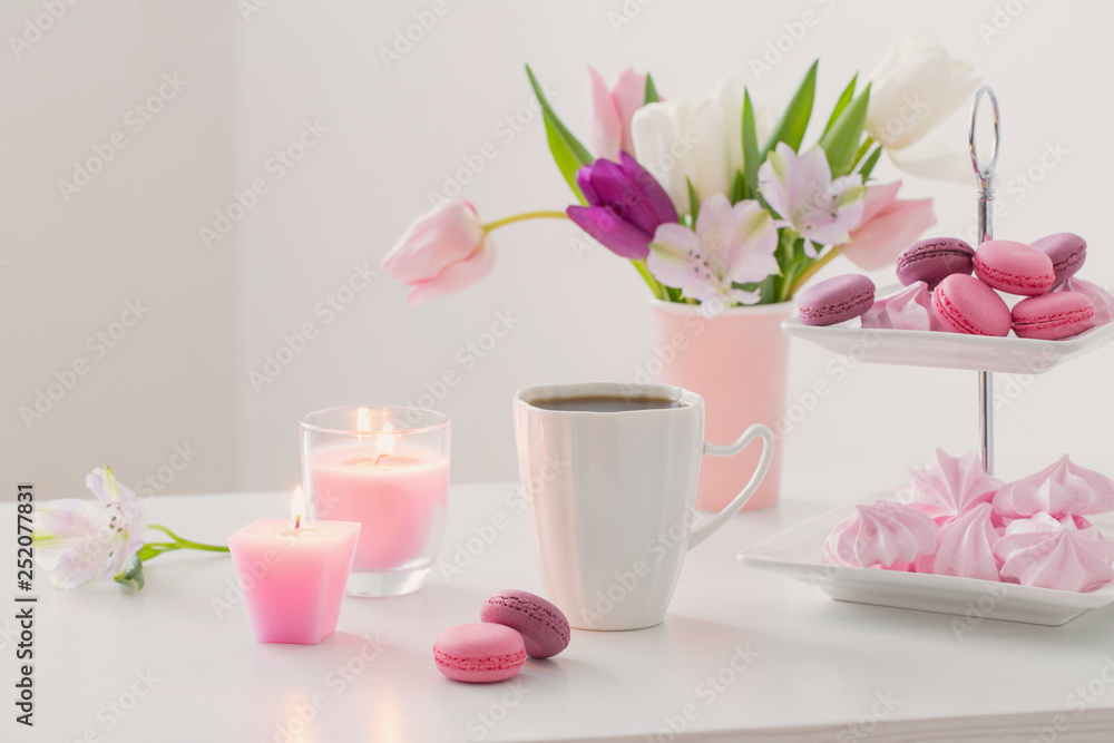 Tulips in vase and cup of coffee with dessert on white background. Concept woman's or mother's day Tulips in vase and cup of coffee with dessert on white background. Concept woman's or mother's day