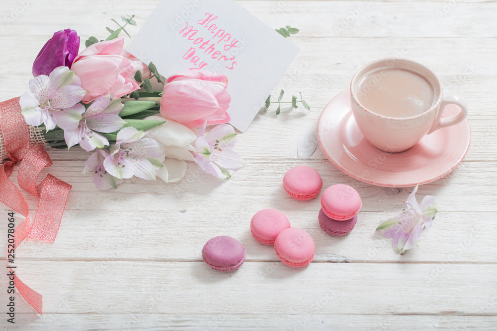 Tulips and cup of coffee with dessert on white background. Concept woman's or mother's day top view Tulips and cup of coffee with dessert on white background. Concept woman's or mother's day top view