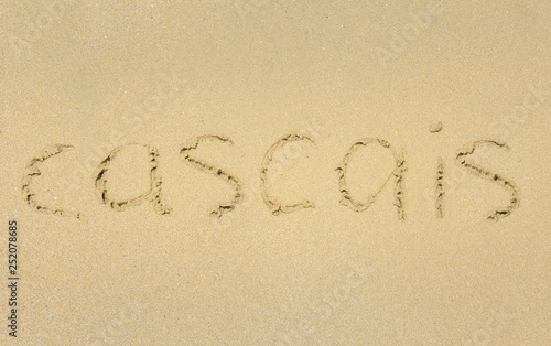 Inscription on wet sand Cascais. 