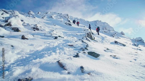 A group of climbers ascending a mountain in winter