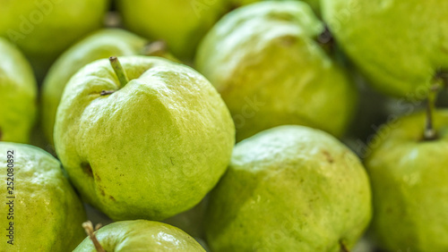 A  green, fresh and tasty guava in the market. © he68