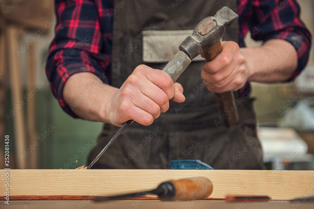 The worker makes measurements of a wooden board with ruler. The worker makes measurements of a wooden board with ruler.