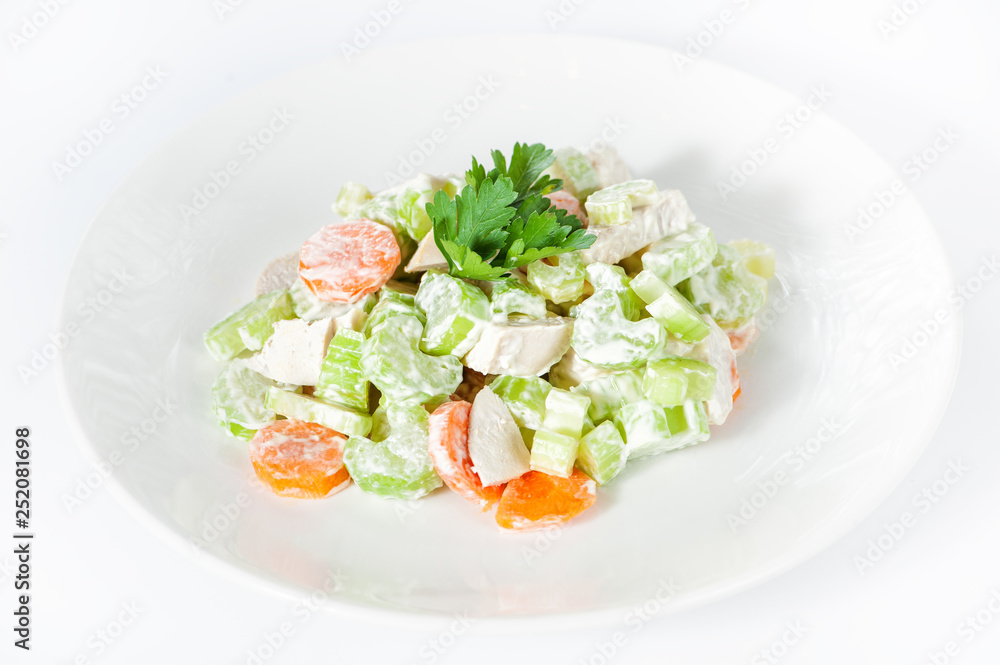 Fresh delicious healthy salad with celery, carrot and meat on white Fresh delicious healthy salad with celery, carrot and meat on white
