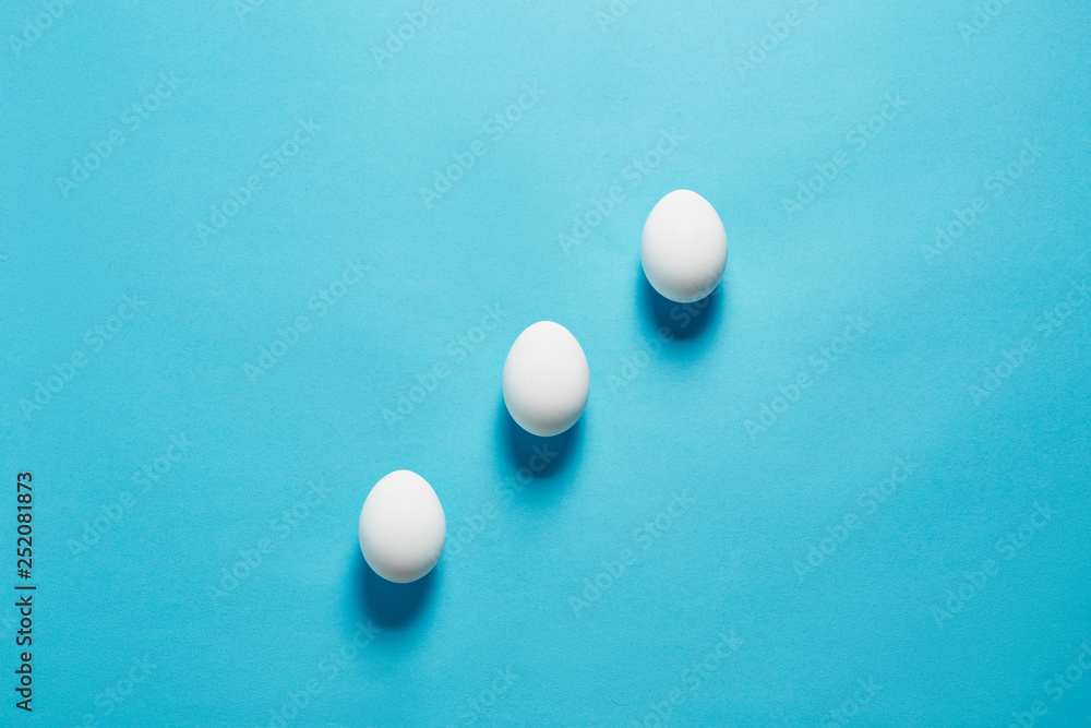 White egg easter on the blue background in center. Design, visual art, minimalist top view copy space White egg easter on the blue background in center. Design, visual art, minimalist top view copy space