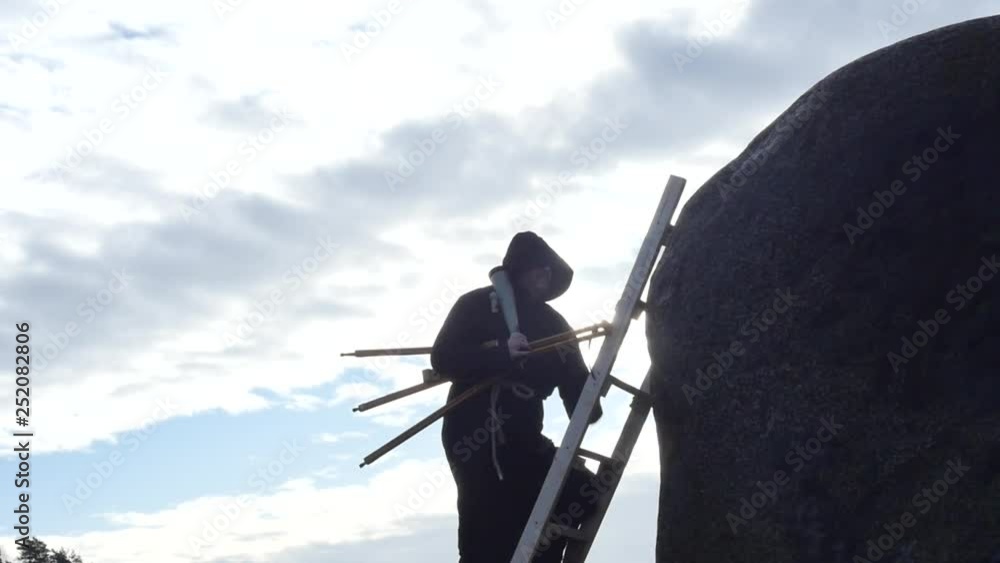 man in hoodie with telescope climbing to the mountains silhouette slow motion man in hoodie with telescope climbing to the mountains silhouette slow motion