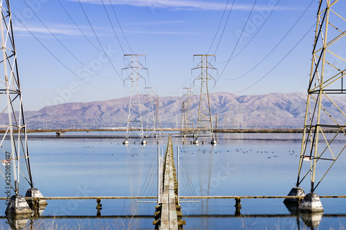 High voltage electricity towers in south San Francisco Bay, Mission peak in the background, California