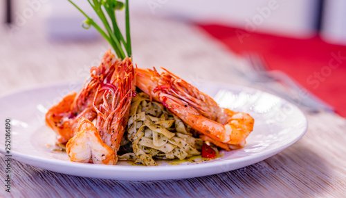 Red shrimps with green organic pasta, fine dining set