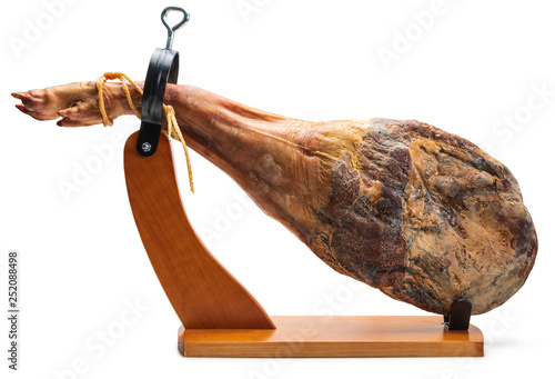 Whole leg of Spanish Iberian serrano ham in wooden support (jamoneror). Isolated on white background.