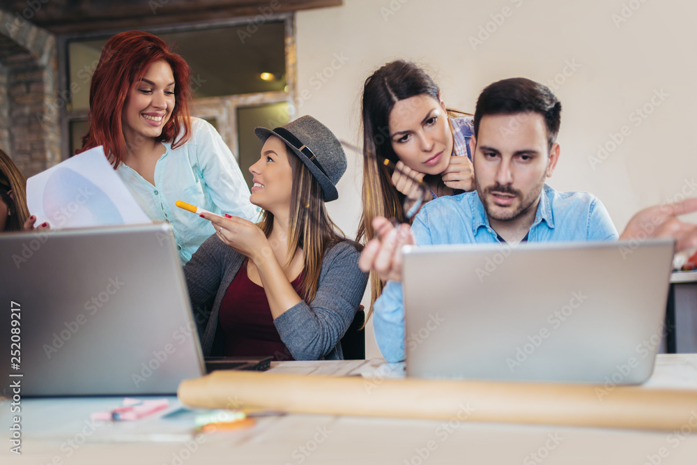 Group of young business people in smart casual wear working together in creative office Group of young business people in smart casual wear working together in creative office