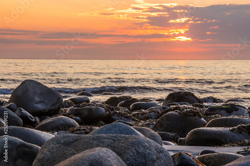 sunset on Unstad beach surrounded by mountains in Lofoten in Norway