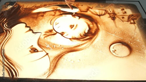 Drawing with sand. Drawing sand on a white screen. Sand Artist. Hands draws