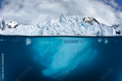 Split view with glacier front above and underwater 