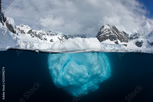 Split view of iceberg above and underwater photo