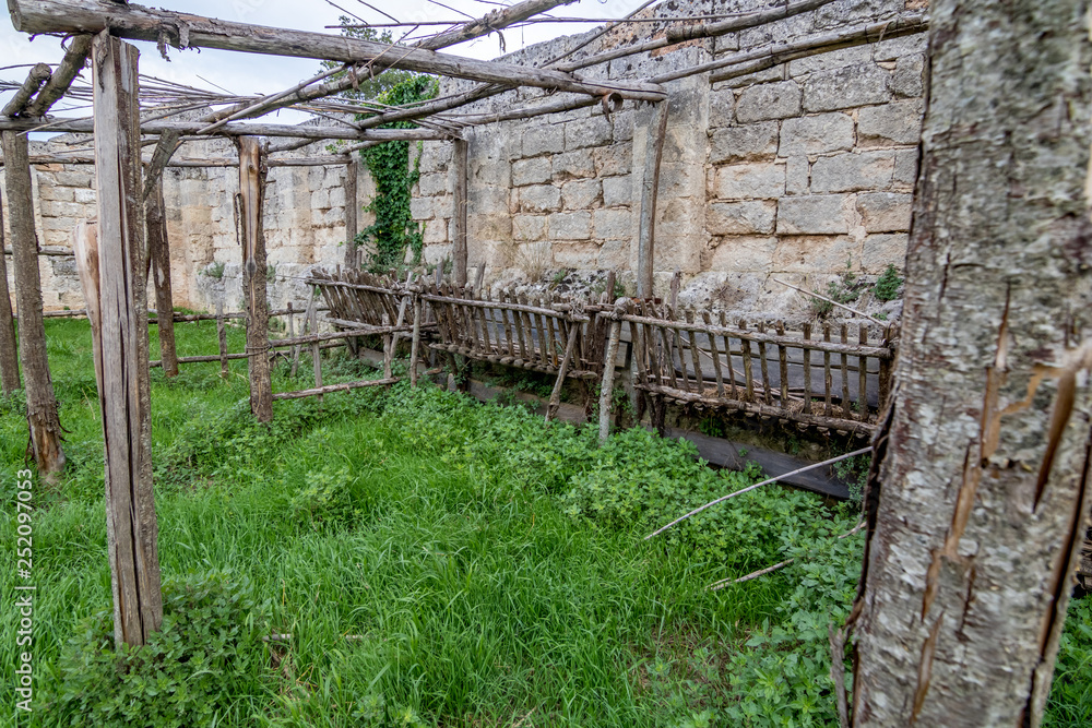 Ancient Italian cave church yard view, cloudy summer afternoon. This ruined religious place is known as Chiesa di San Falcione and is close to Matera, Basilicata region, South Italy Ancient Italian cave church yard view, cloudy summer afternoon. This ruined religious place is known as Chiesa di San Falcione and is close to Matera, Basilicata region, South Italy