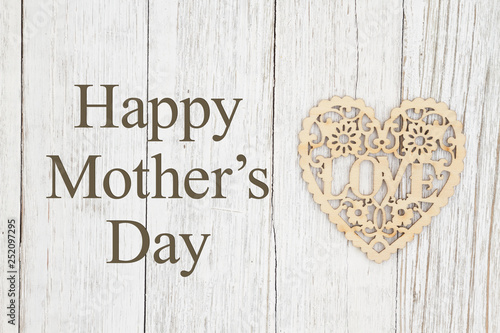 Happy Mother's Day greeting with wood heart on weathered wood