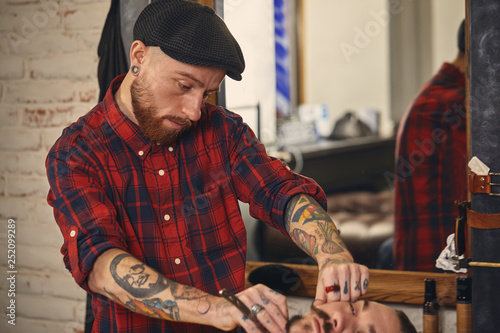 Client during beard shaving in barber shop © nazarovsergey