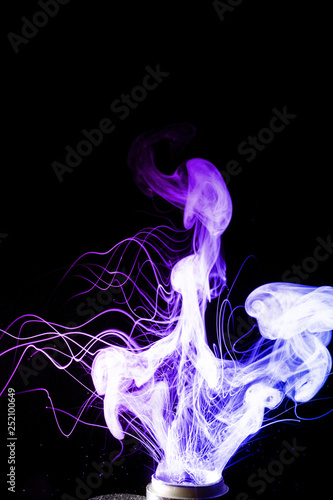 Colorful clouds of vape fog. Splash of colour and glicerine clouds with boling splay of liquid, purple and blue colours. Vape culture and no smoking movement.