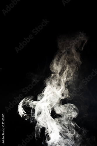Vape steam spread with spray boiling liquid. Stock photo isolated on black background. Vape culture outreach. Conceptual image.