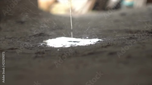 Urine flows through the ground close up. Peeing on the ground photo