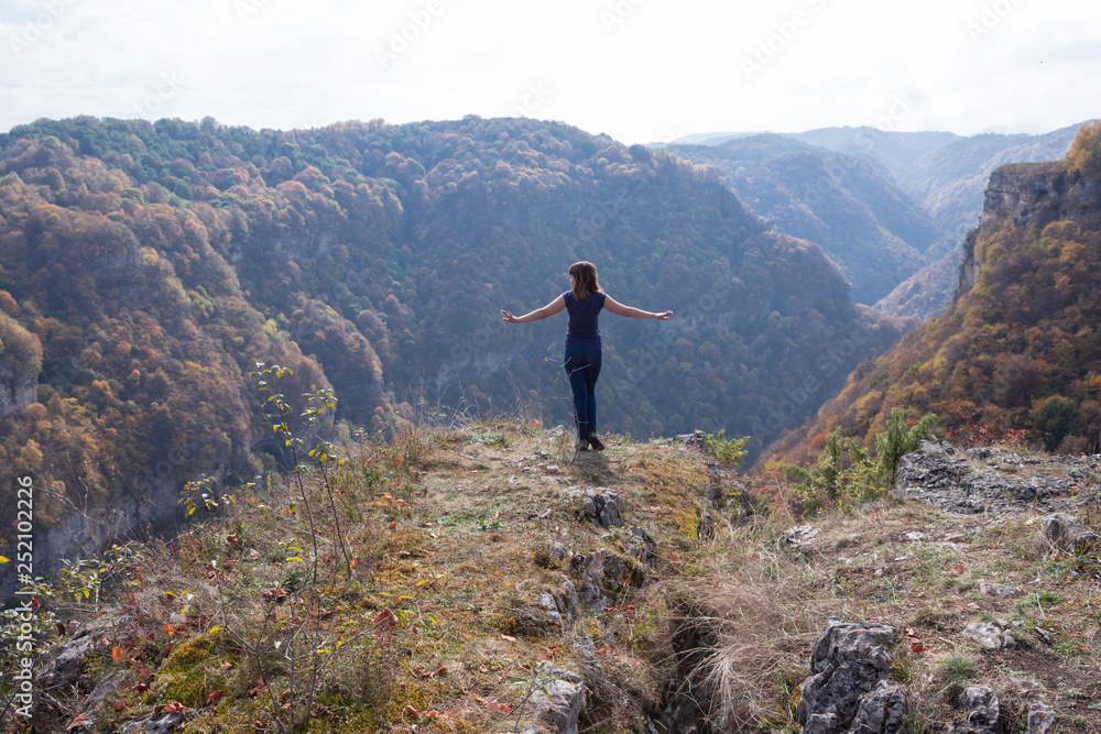 a young girl admires the view of the mountains a young girl admires the view of the mountains