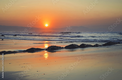  Beautiful sunset with orange tones on Barrika beach, vizcaya, Basque Country, Spain