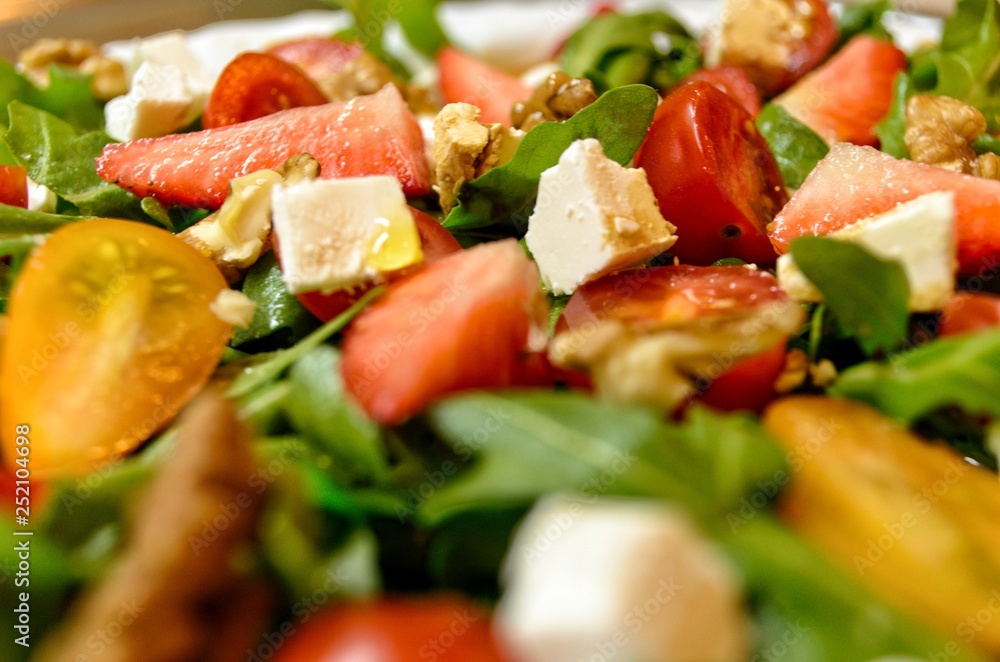 Fresh and healthy salad with fruits, vegetable, rocket and nuts Fresh and healthy salad with fruits, vegetable, rocket and nuts