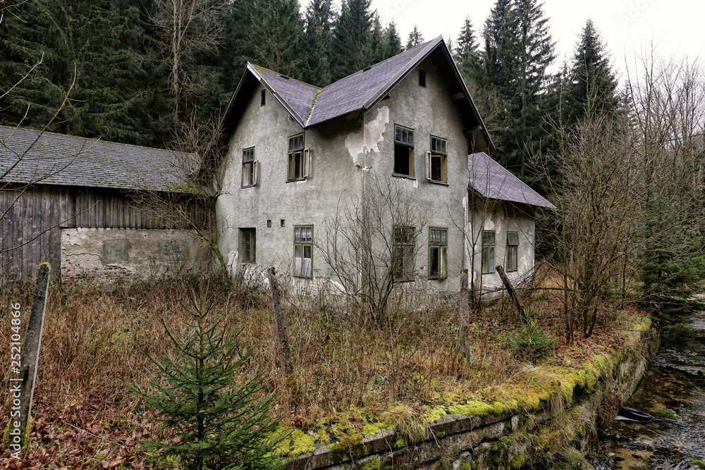 Old abandoned house with open windows by the river Old abandoned house with open windows by the river