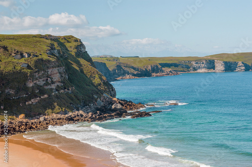 Mediterranean seacoast, Cantabria, Spain. Rocks, seaside, white foam and teal sea ocean water